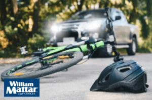 crashed bike and helmet in front of a car